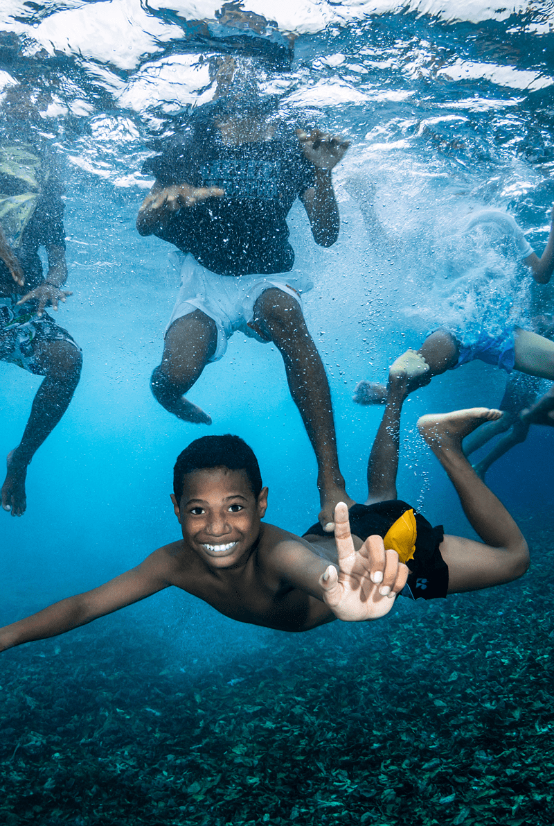 Kids swimming in Raja Ampat, Indonesia