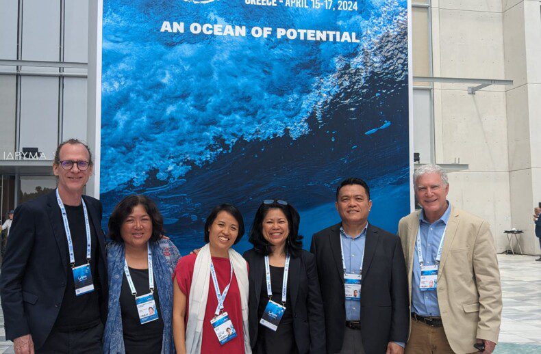 Group of conservation leaders at Our Ocean Greece event: Left to Right - Mr. Martin Callow (Regional Director, South-East Asian Archipelago, Wildlife Conservation Society), Ms. Rili Djohani (Advisory Member, Coral Triangle Conservation Fund), Ms. Boon Pei Ya (Regional Conservation Finance Programme Manager, South-East Asian Archipelago, Wildlife Conservation Society), Dr. Yang Mee Eng (CEO, Coral Triangle Conservation Fund), Dr. Chris Rotinsulu (Deputy Director of Coral Triangle initiative on Coral Reefs, Fisheries and Food Security Regional Secretariat), Dr. David Meyers (Executive Director, Conservation Finance Alliance) standing confidently in front of event banner.